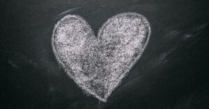 solid chalk heart on black chalkboard